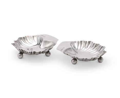 
	
		A PAIR OF VICTORIAN SILVER SHAPED BUTTER DISHES
		HORACE WOODWARD &amp; CO., LONDON 1887
		On three ball feet
		12cm (4 