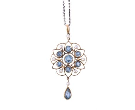 
	
		AN EDWARDIAN AQUAMARINE AND SEED PEARL PENDANT 
		CIRCA 1910
		The pierced floral pendant with a central circular cut aq