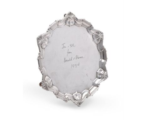 
	
		AN EDWARDIAN SILVER SHAPED CIRCULAR SALVER
		WILLIAM HUTTON &amp; SONS LTD., LONDON 1903
		With a shell and scroll borde