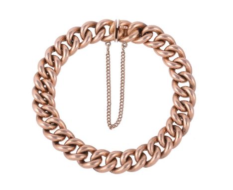 
	
		A LATE VICTORIAN GOLD CURB LINK BRACELET
		The bracelet with solid links to a concealed clasp, the tongue with rubbed ma