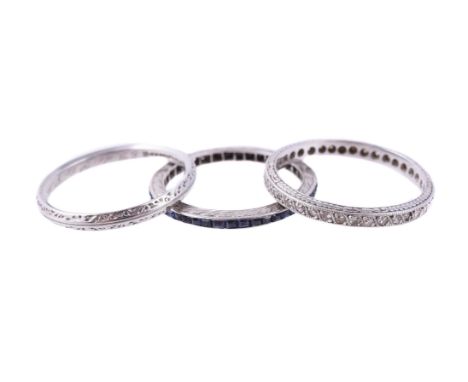 
	
		TWO GEM SET 1920S ETERNITY RINGS AND A 1940S BAND RING
		The first with eight cut diamonds, approximately 0.20 carats to