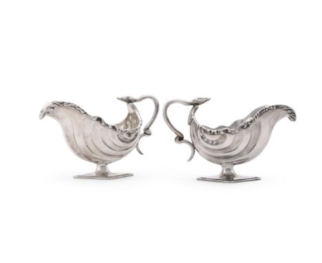 
	
		A PAIR OF VICTORIAN SILVER OVAL PEDESTAL SAUCE BOATS
		THOMAS HAYES, BIRMINGHAM 1898
		With chased foliate borders, serp
