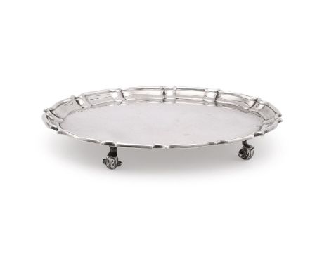 
	
		AN EDWARDIAN SILVER SHAPED OVAL TEA POT STAND
		SIBRAY, HALL &amp; CO. LTD., LONDON 1909
		With a raised moulded border 