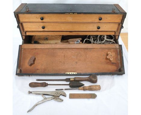 CARPENTERS TOOL CHEST
with metal forged corners and drop down front revealing a storage compartment and two drawers with vari