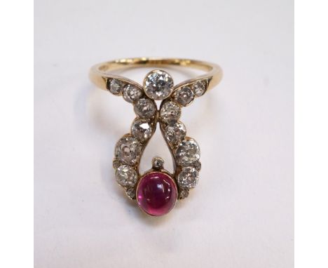 UNUSUAL DIAMOND AND RUBY DRESS RING
circa 1900, the diamonds in shaped setting totalling approximately 1.3cts around a single