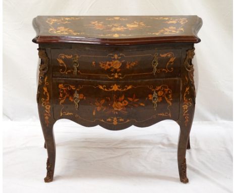 CONTINENTAL WALNUT AND INLAID SMALL COMMODE
with a moulded top inlaid with floral motifs, above two inlaid drawers, standing 