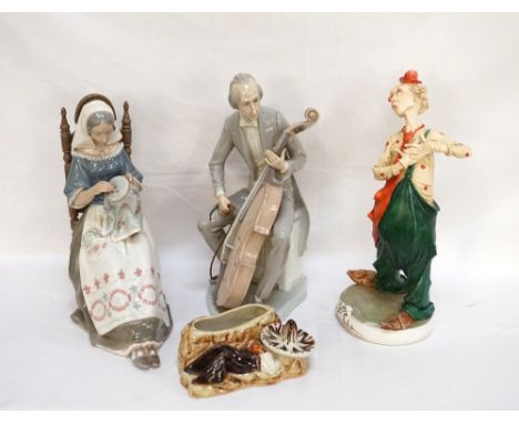 LLADRO PORCELAIN FIGURE OF A MUSICIAN
playing a cello dressed in a tail coat, 31cm high; a Lladro figure of a young lady sat 