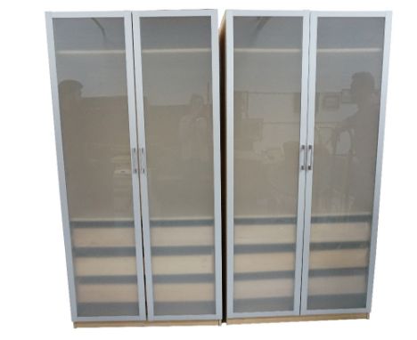 PAIR OF LIGHT ASH STYLE WARDROBES
with a pair of opaque panel doors opening to reveal a hanging rail above three drawers, sta
