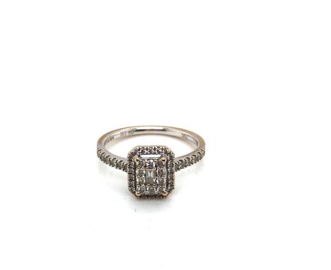 An 18ct white gold hallmarked multi-diamond double cluster ring complete with diamond set shoulders. The stated diamond weigh