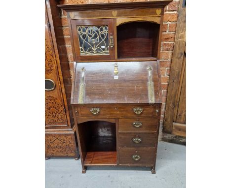 A Liberty's Arts and Crafts mahogany bureau bookcase, three hearts inlaid on a satinwood band below the cornice, an open shel