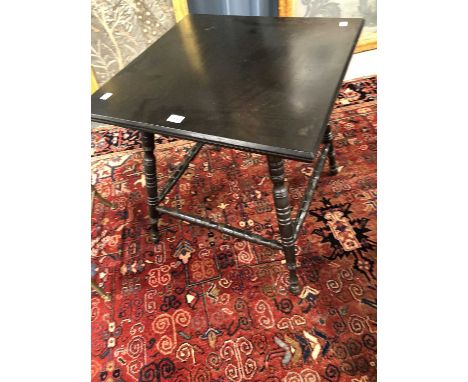 An Aesthetic Movement ebonised occasional table, the square top on four ring turned legs united by stretchers, 60cm high x 58