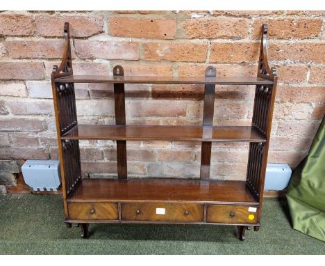 A Chippendale style mahogany wall unit of three open shelves over three drawers between sides pierced with gothic arches.   W