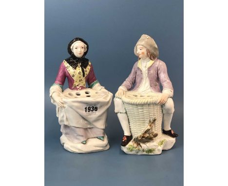 A pair of patch mark Derby figures, each seated, he before a basket pierced with holes at its top and she with a pierced tray