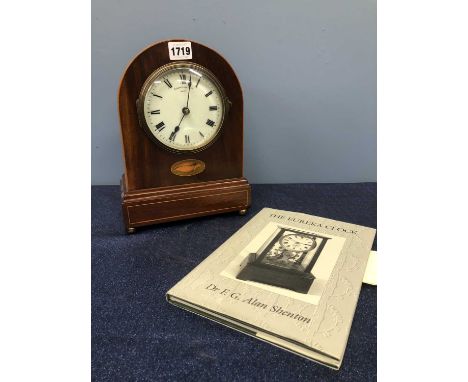 A Eureka Clock Co. Ltd battery operated mantel clock No. 2508, the round arch mahogany case with a shell inlaid below the cir