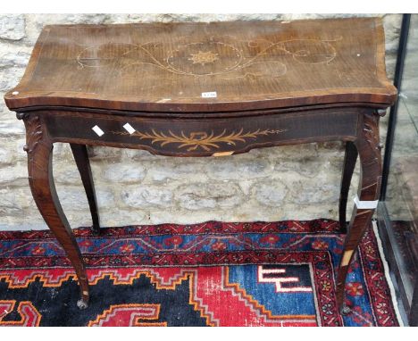 A French style Georgian rosewood cross banded and tendril marquetried games table opening on a single gate, the cabriole legs