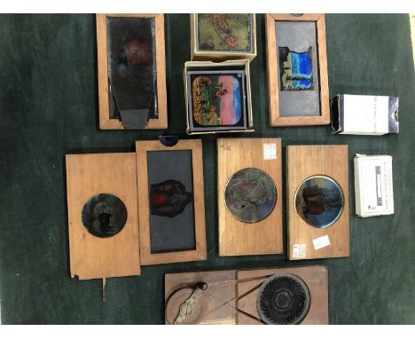 Carpenter &amp; Westley mahogany framed glass magic lantern slides: a rotary action kaleidoscopic slide and three sliding gla