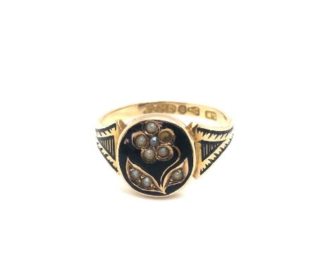 An antique 9ct hallmarked seed peal and black enamel memorial ring. Finger size Q. Weight 2.28 grams.