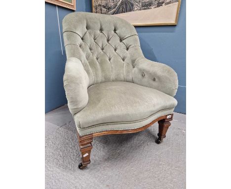 A Victorian mahogany armchair, the button upholstered hoop back above tapering square front legs on black ceramic caster feet