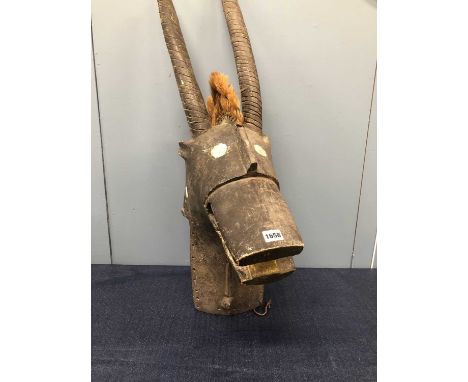 An African carved wood antelope helmet mask, possibly Kobo, painted black with white eyes and a crest of tousled mane.   H 94