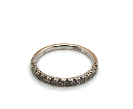 An 18ct white gold hallmarked diamond set fifteen stone half eternity ring. Stated diamond weight 0.50cts. Finger size P.