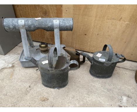 AN ASSORTMENT OF ITEMS TO INCLUDE AN OIL JUG, A VINTAGE PARAFIN GREENHOUSE HEATER AND TWO WATERING CANS 