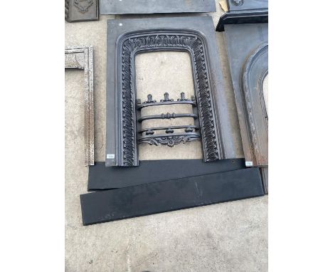 A LARGE DECORATIVE CAST IRON FIRE PLACE AND SURROUND 