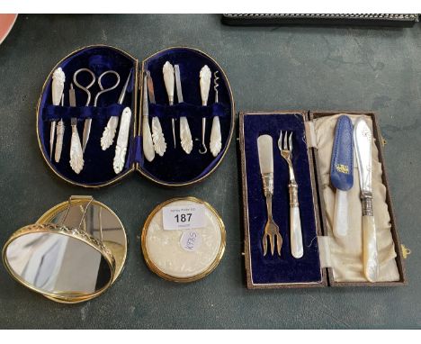 TWO VINTAGE DECORATIVE LADIES DRESSING TOOL CASES WITH MOTHER OF PEARL HANDLES PLUS A MIRROR AND POWDER COMPACT 