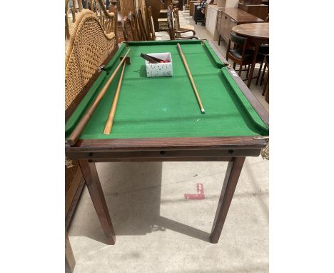 A MODERN SNOOKER TABLE, 64X34" COMPLETE WITH BALLS, TRIANGLE, TWO CUES AND A REST 