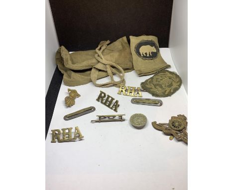A CANVAS POUCH CONTAINING VARIOUS ARMY BADGES 