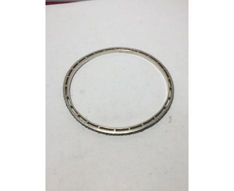 A SILVER BANGLE WITH DIAMOND CHIPS (SOME MISSING) 
