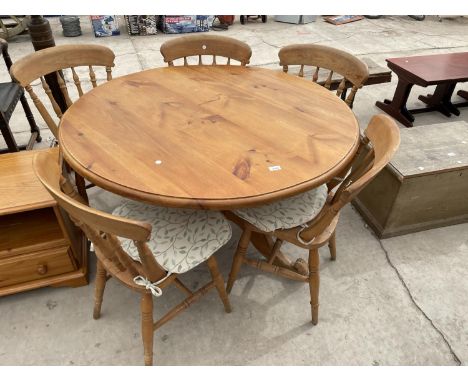 A VICTORIAN STYLE PINE TRIPOD KITCHEN TABLE, 47" DIAMETER TOGETHER WITH FOUR CHAIRS 