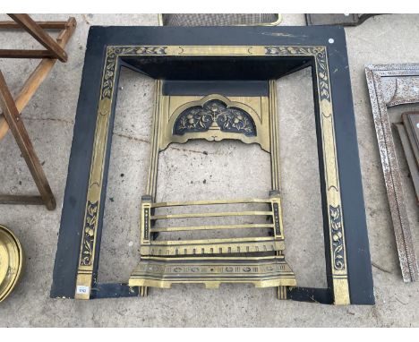 A DECORATIVE GILT AND BLACK CAST IRON FIRE SURROUND 