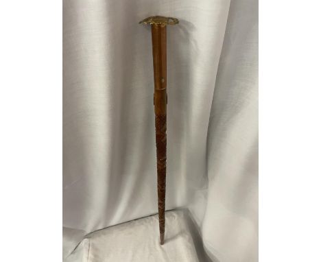 A COPPER AND BRASS TOPPED ENGRAVED WOODEN ARMY STYLE WALKING STICK 