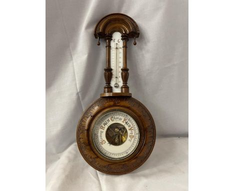 A DECORTIVE WALL BARROMETER WITH THERMOMETER A/F CRACKED GLASS ACROSS THE THERMOMETER 