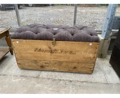 A PINE TRUNK WITH PADDED BUTTON SEAT BEARING STENCIL 'CARTE D'OR 1904' WITH BRASS SCOOP HANDLES 