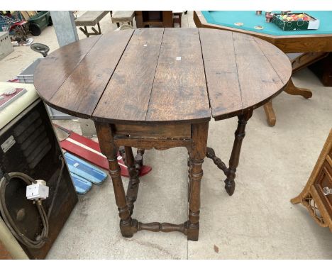 A GEORGE III OAK GATELEG DINING TABLE 
