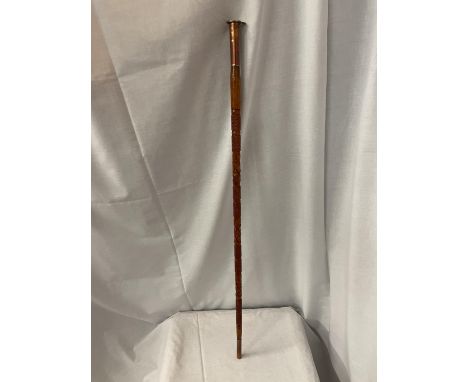 A COPPER AND BRASS TOPPED ENGRAVED WOODEN ARMY STYLE WALKING STICK 