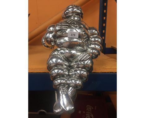 A CHROME SHELF PUPPET OF MICHELIN MAN 