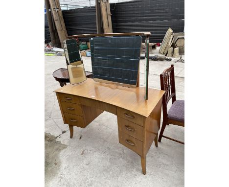 A RETRO TEAK INVERTED BOWFRONTED DRESSING TABLE ENCLOSING SEVEN DRAWERS, 46" WIDE, WITH TRIPLE MIRROR 