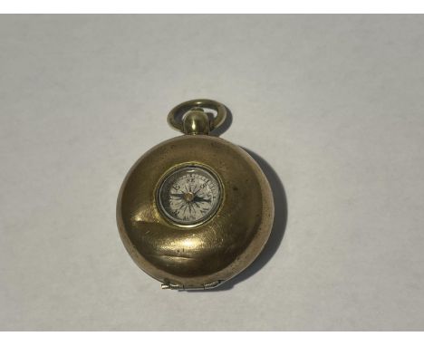 A GOLDPLATED SOVEREIGN CASE WITH COMPASS 