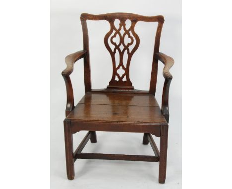 LATE EIGHTEENTH CENTURY OAK OPEN ARMCHAIR, with shaped  top rail, pierced splat and outswept arms, enclosing a flat fronted s