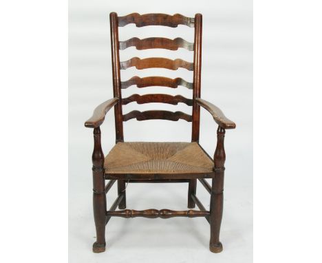 ANTIQUE ELM AND STAINED FRUITWOOD LADDER BACK OPEN ARMCHAIR, the six graduated horizontal splats and outswept arms above a fl