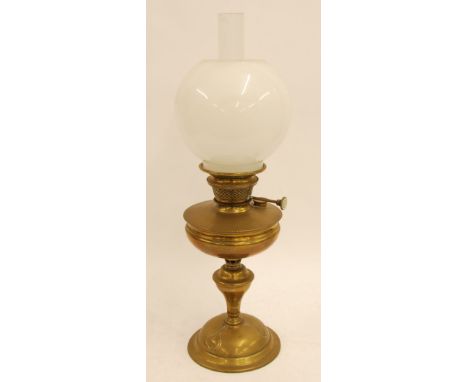 ART NOUVEAU EMBOSSED BRASS OIL TABLE LAMP with clear chimney and opaque white orbicular shade, 23 1/2" (59.7cm) high overall 