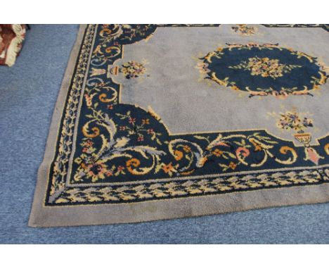 PROBABLY EARLY TWENTIETH CENTURY DONEGAL CARPET, with a plain pale blue field, with dark blue  and floral oval centre medalli