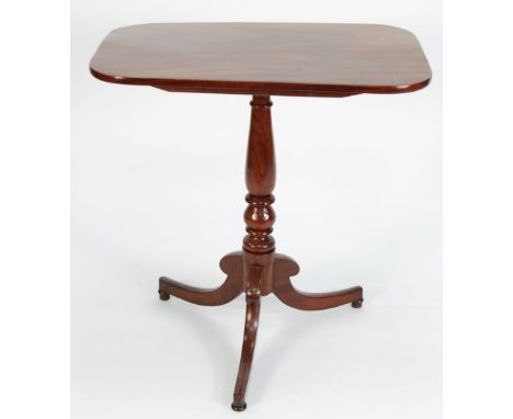 EARLY NINETEENTH CENTURY MAHOGANY TRIPOD OCCASIONAL TABLE, the rounded oblong top above a turned column and raised on outswep