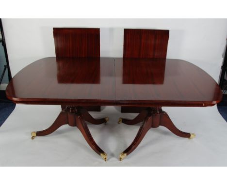 REGENCY STYLE MAHOGANY D-END DOUBLE PEDESTAL DINING TABLE on tripod supports with brass paw feet and casters and one loose le