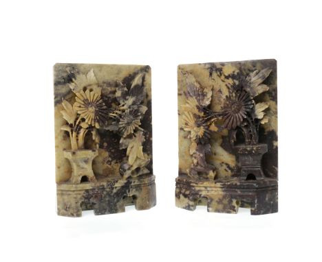 PAIR OF 20TH CENTURY CHINESE SOAPSTONE CARVINGSmodelled with florals against a rectangular backdrop and as if on a shelf, 15c