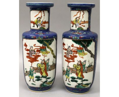 A PAIR OF 19TH CENTURY CHINESE FAMILLE VERTE BLUE GROUND ROULEAU PORCELAIN VASES, each painted with a panel of figures on a g