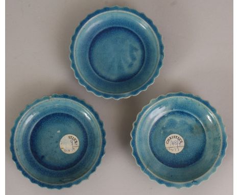 A GROUP OF THREE CHINESE KANGXI PERIOD TURQUOISE GLAZED PORCELAIN DISHES, each with a barbed and moulded lappet rim, two of t