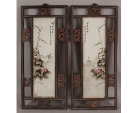 A PAIR OF CHINESE WOOD FRAMED FAMILLE ROSE PORCELAIN PLAQUES, each plaque decorated with calligraphy and with a dragonfly abo